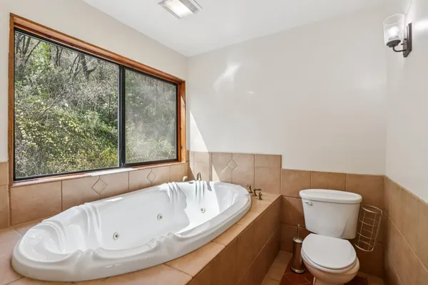 a bathroom with a toilet and a large window