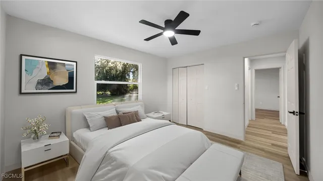 a bedroom with a large bed and a window