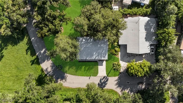 an aerial view of a house with a yard and garden