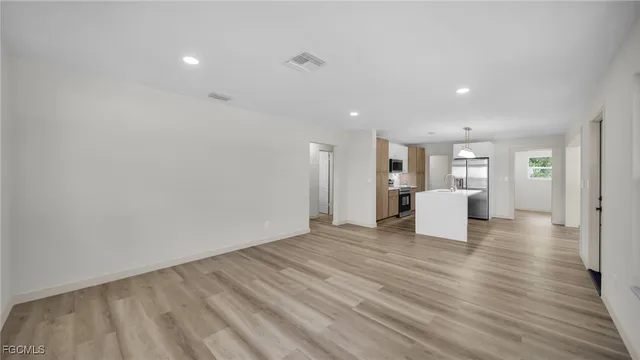 a view of a room with wooden floor