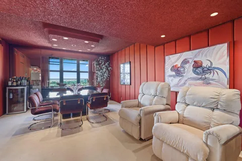 an aerial view of lake residential house with outdoor space and trees around