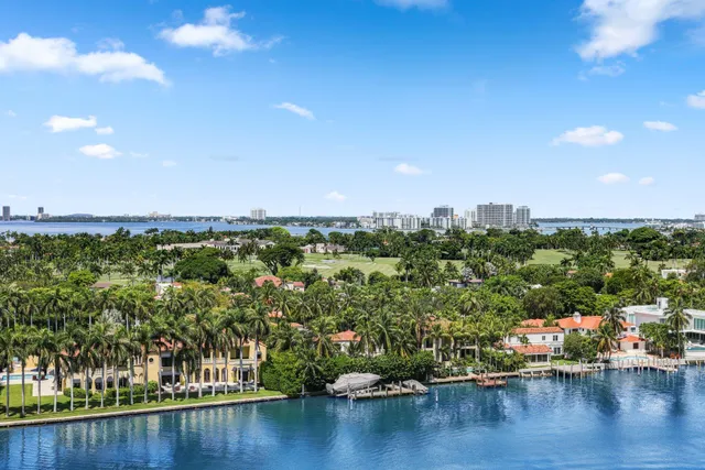 a kitchen with a refrigerator and white cabinets
