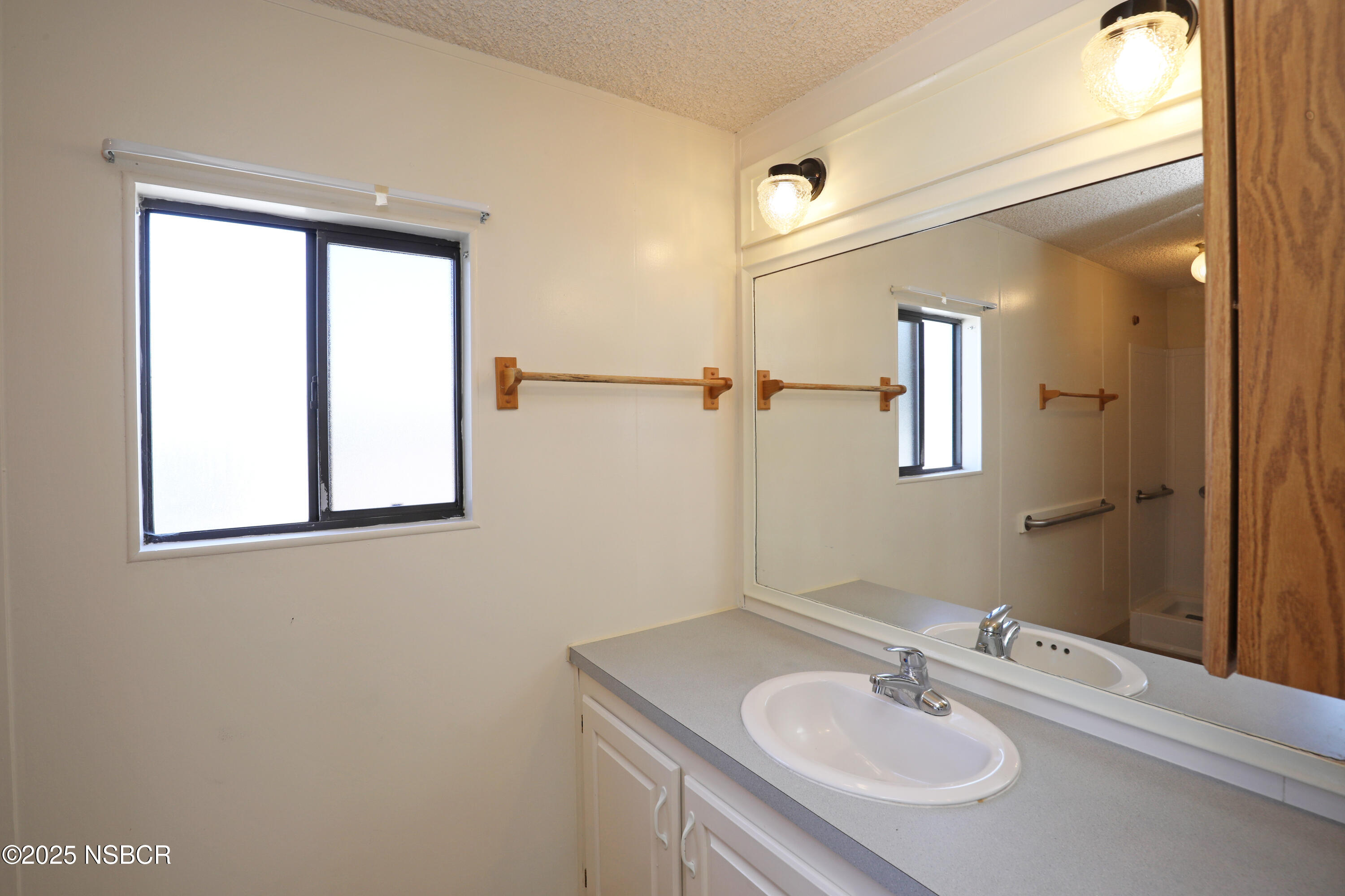 80 Zaca Street, Unit 4 Buellton, CA 93427 - Photo 16 of 25 a bathroom with a sink and a mirror
