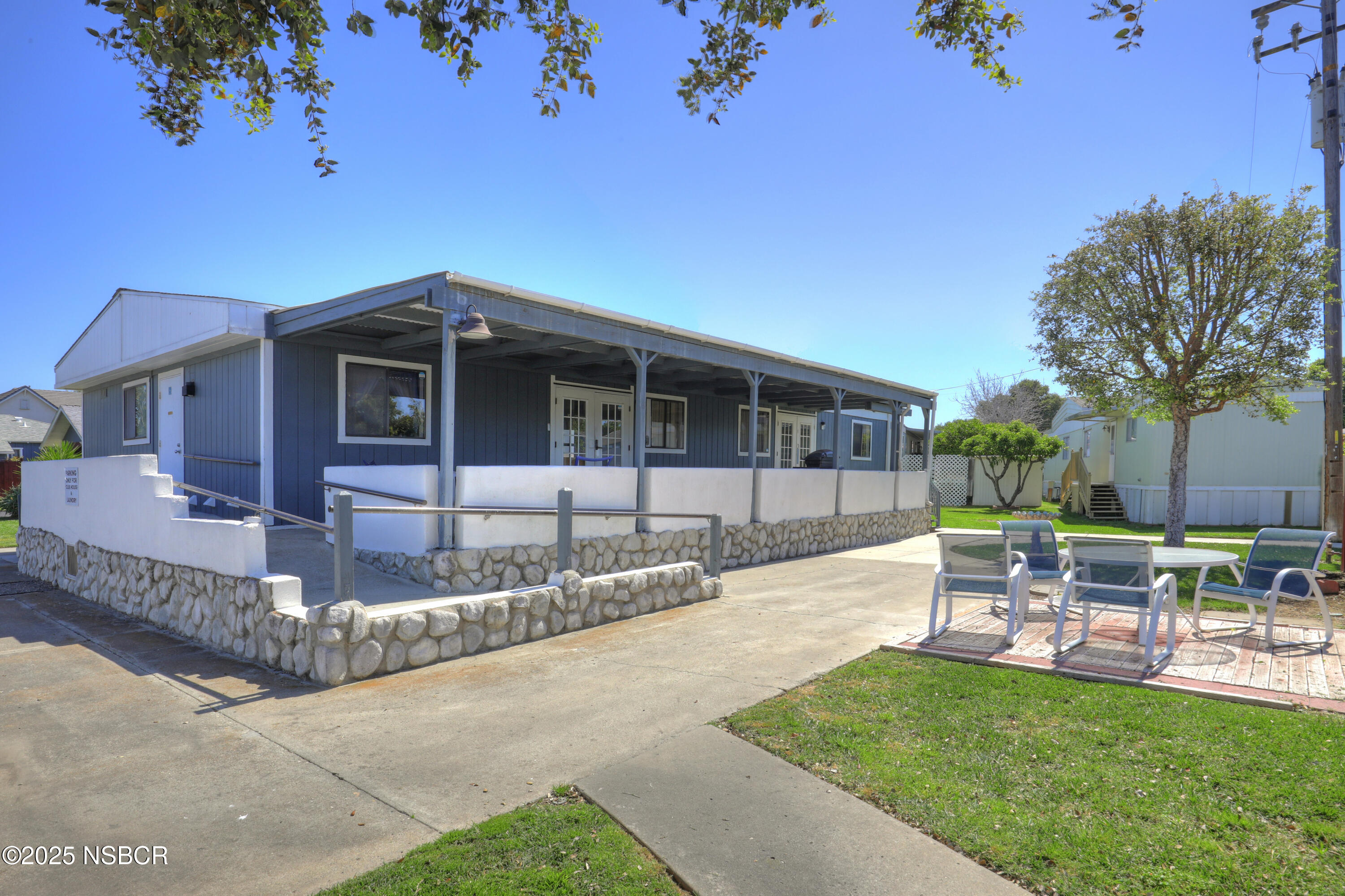 80 Zaca Street, Unit 4 Buellton, CA 93427 - Photo 22 of 25 a front view of a house with a garden and sitting area