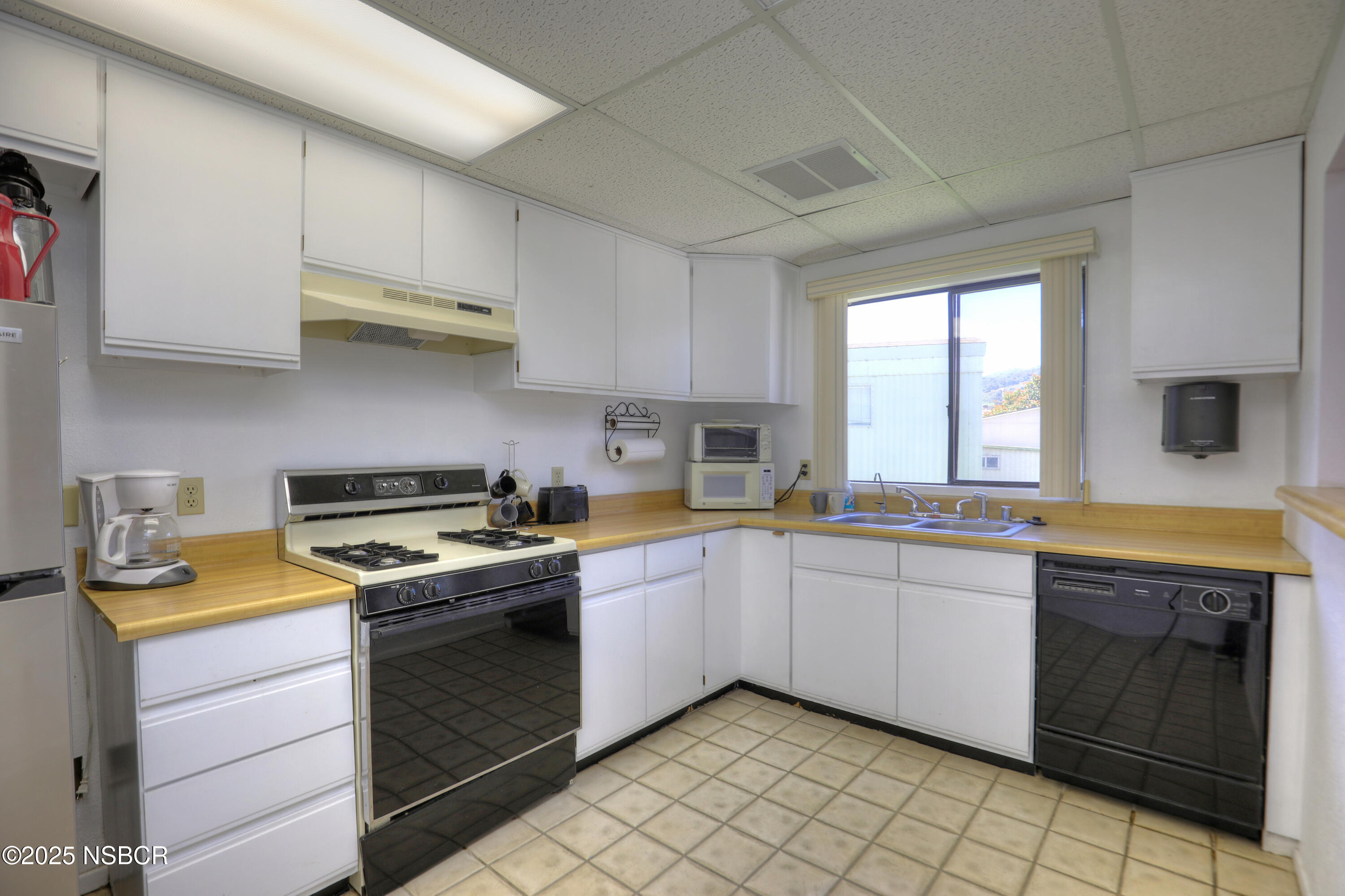 80 Zaca Street, Unit 4 Buellton, CA 93427 - Photo 25 of 25 a kitchen with a stove sink and cabinets