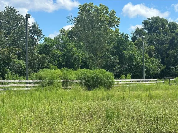a backyard of a house with a yard and outdoor seating