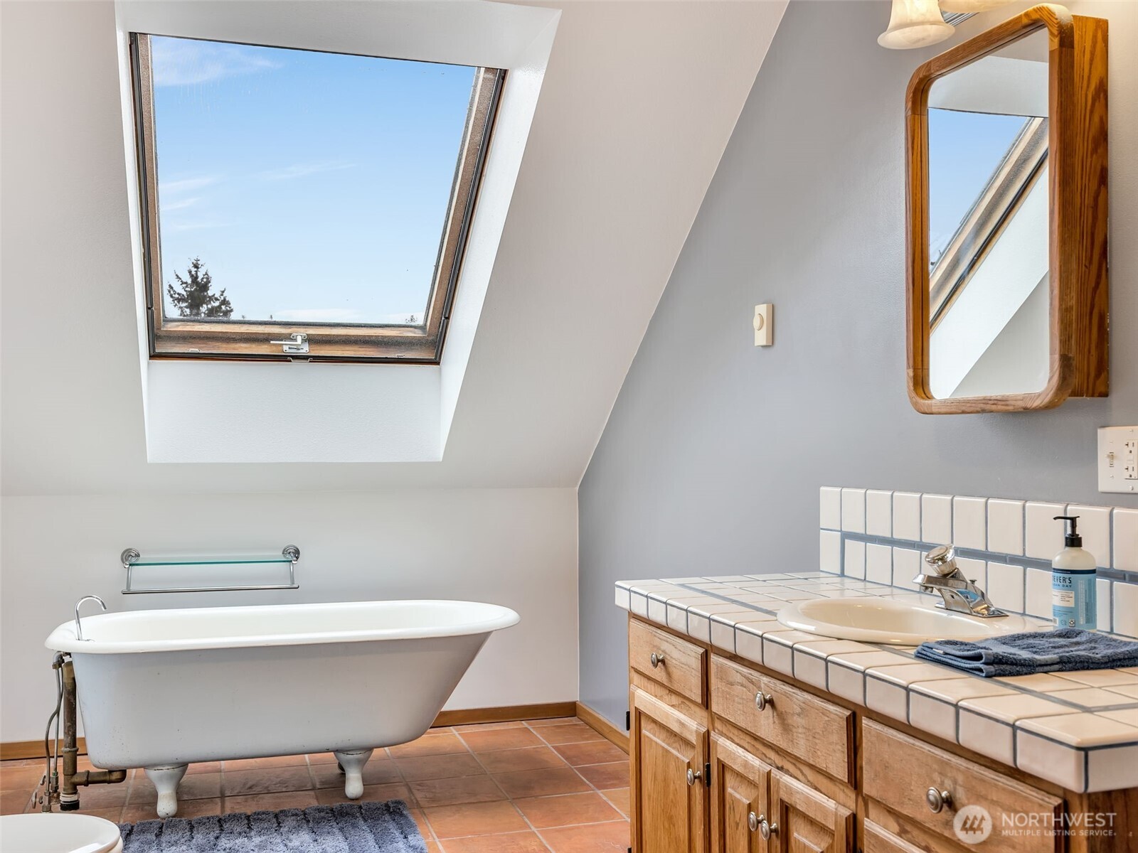 20003 Sandridge Road Long Beach, WA 98631 - Photo 36 of 39 a bathroom with a granite countertop sink and a mirror