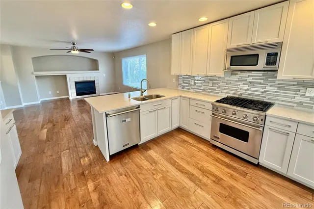a kitchen with a sink stove and microwave