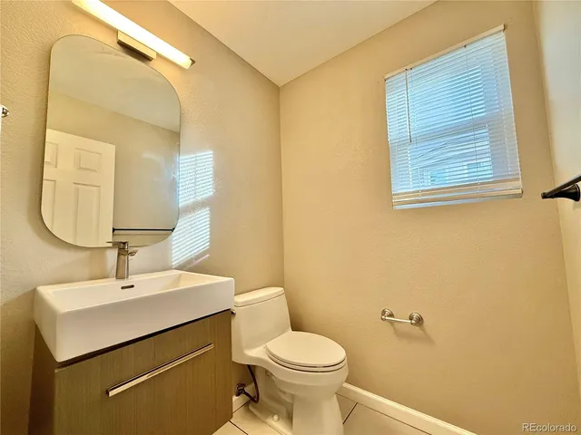 a bathroom with a sink mirror and toilet