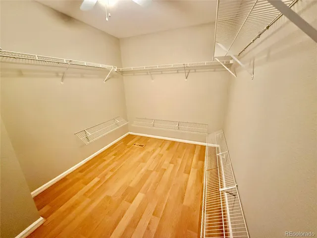 a view of a room with wooden floor and door