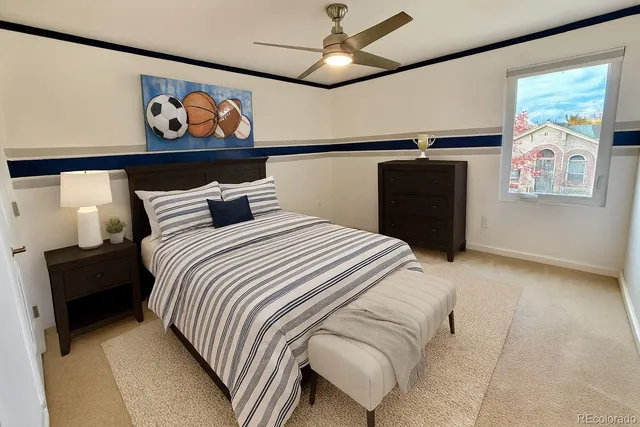 a bedroom with a bed and painting on the wall