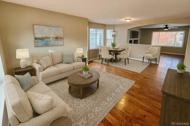 a living room with furniture and wooden floor