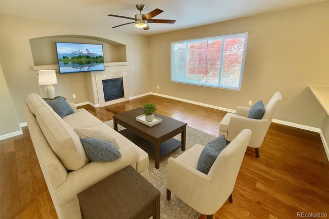 a living room with furniture and a wooden floor
