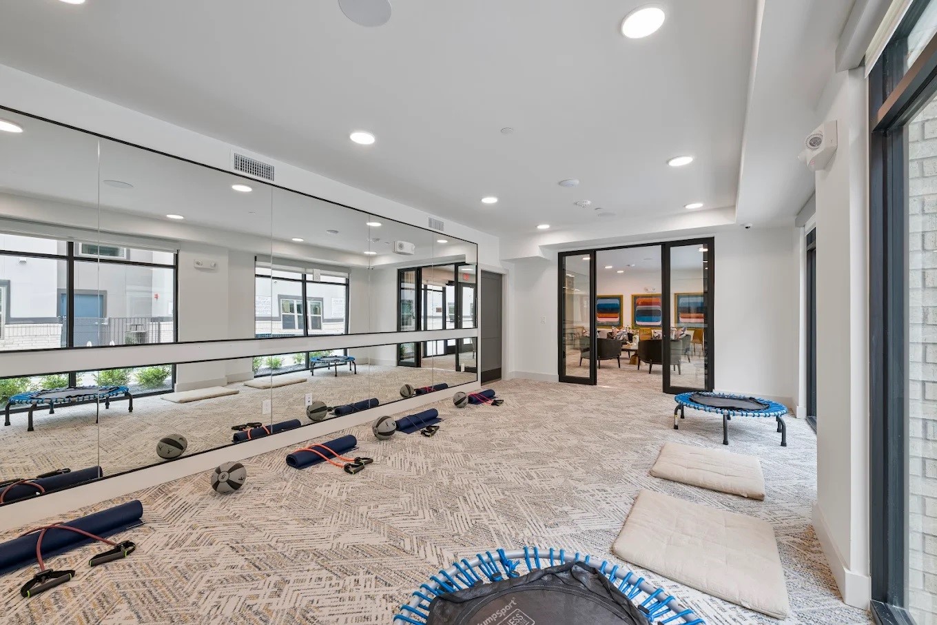 1888 Brittmoore Road, Unit 1424 Houston, TX 77043 - Photo 13 of 16 a large room with gym equipment and mirror