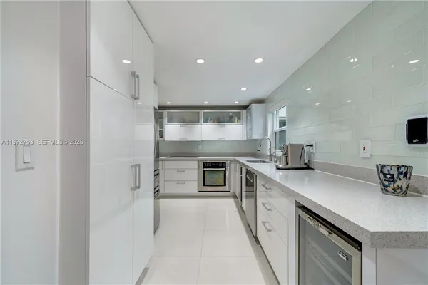 a kitchen with stainless steel appliances granite countertop a sink and stove top oven