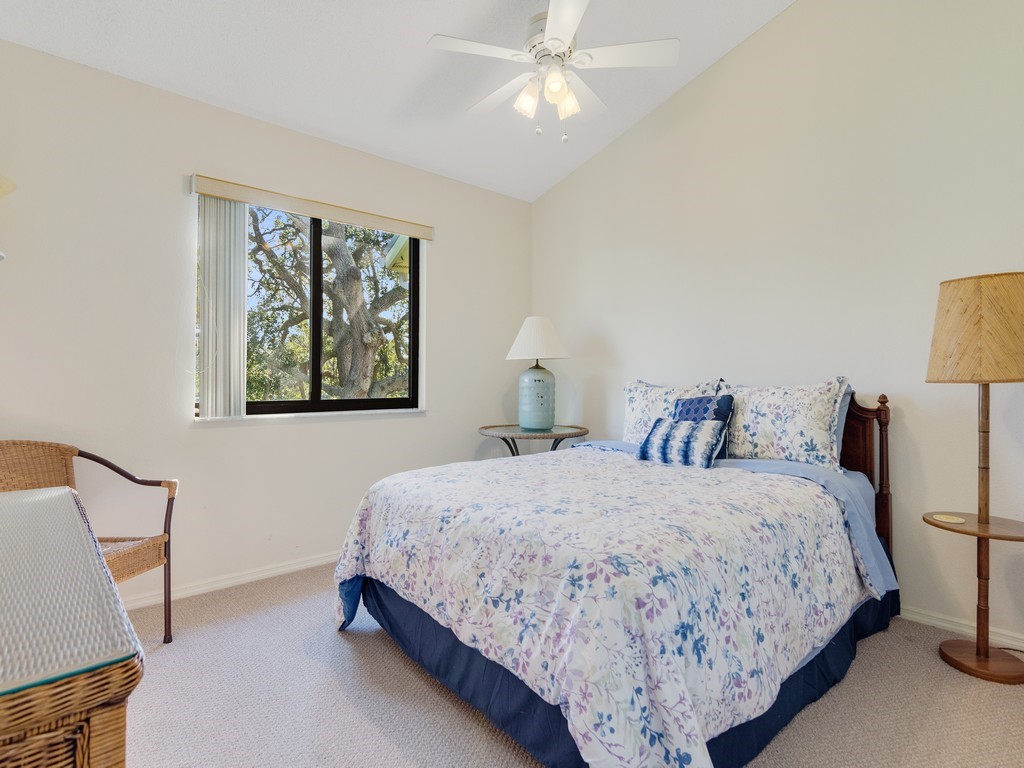 5735 Marina Drive, Unit 3 Sebastian, FL 32958 - Photo 13 of 36 a bedroom with a bed and a painting on the wall