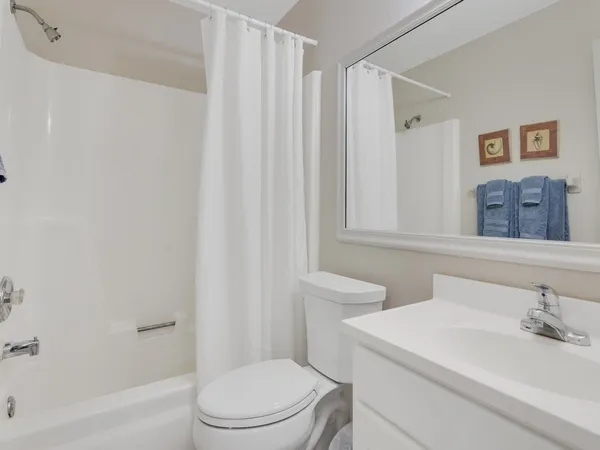 a white toilet sitting next to a bathroom sink