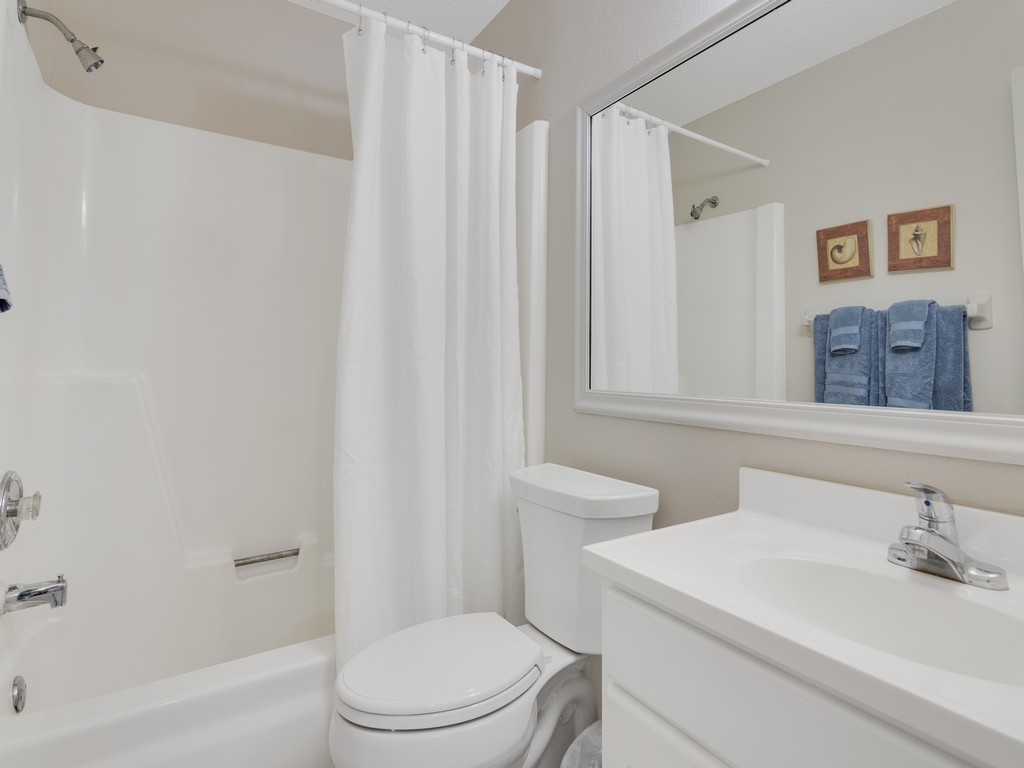 5735 Marina Drive, Unit 3 Sebastian, FL 32958 - Photo 14 of 36 a white toilet sitting next to a bathroom sink