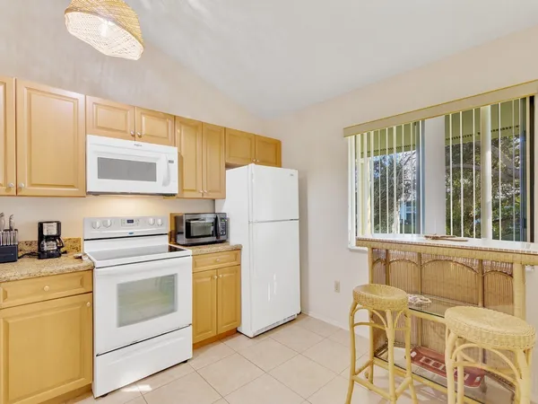 a kitchen with a stove a sink and a refrigerator