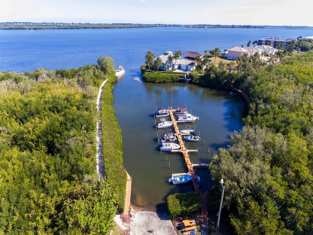 5735 Marina Drive, Unit 3 Sebastian, FL 32958 - Photo 27 of 36 a view of a lake with a house in the background