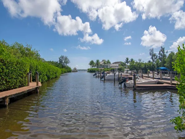 a swimming pool with outdoor seating and lake view