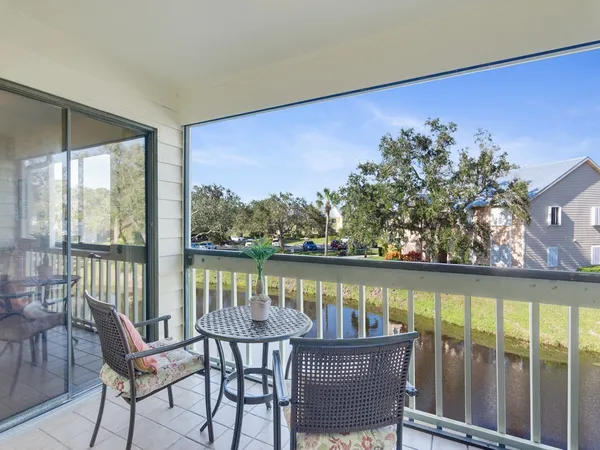 a view of a chairs and table in the balcony