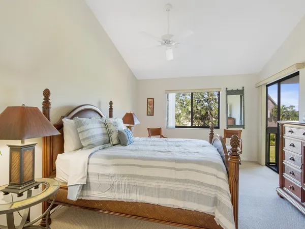 a bedroom with a large bed and a chandelier