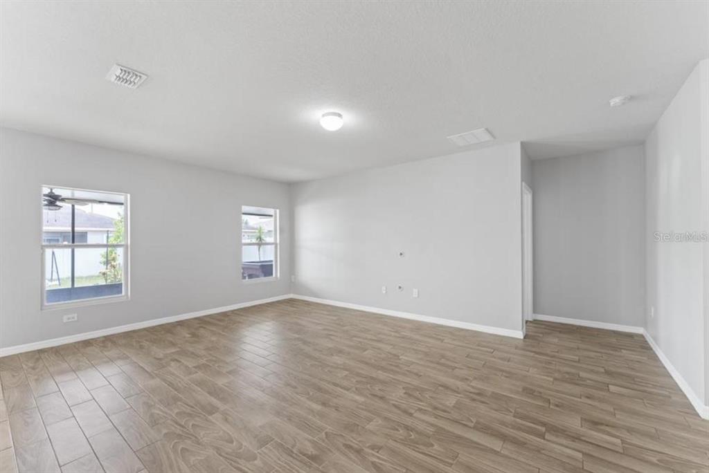 237 Tanager Street Haines City, FL 33844 - Photo 4 of 5 an empty room with wooden floor and window