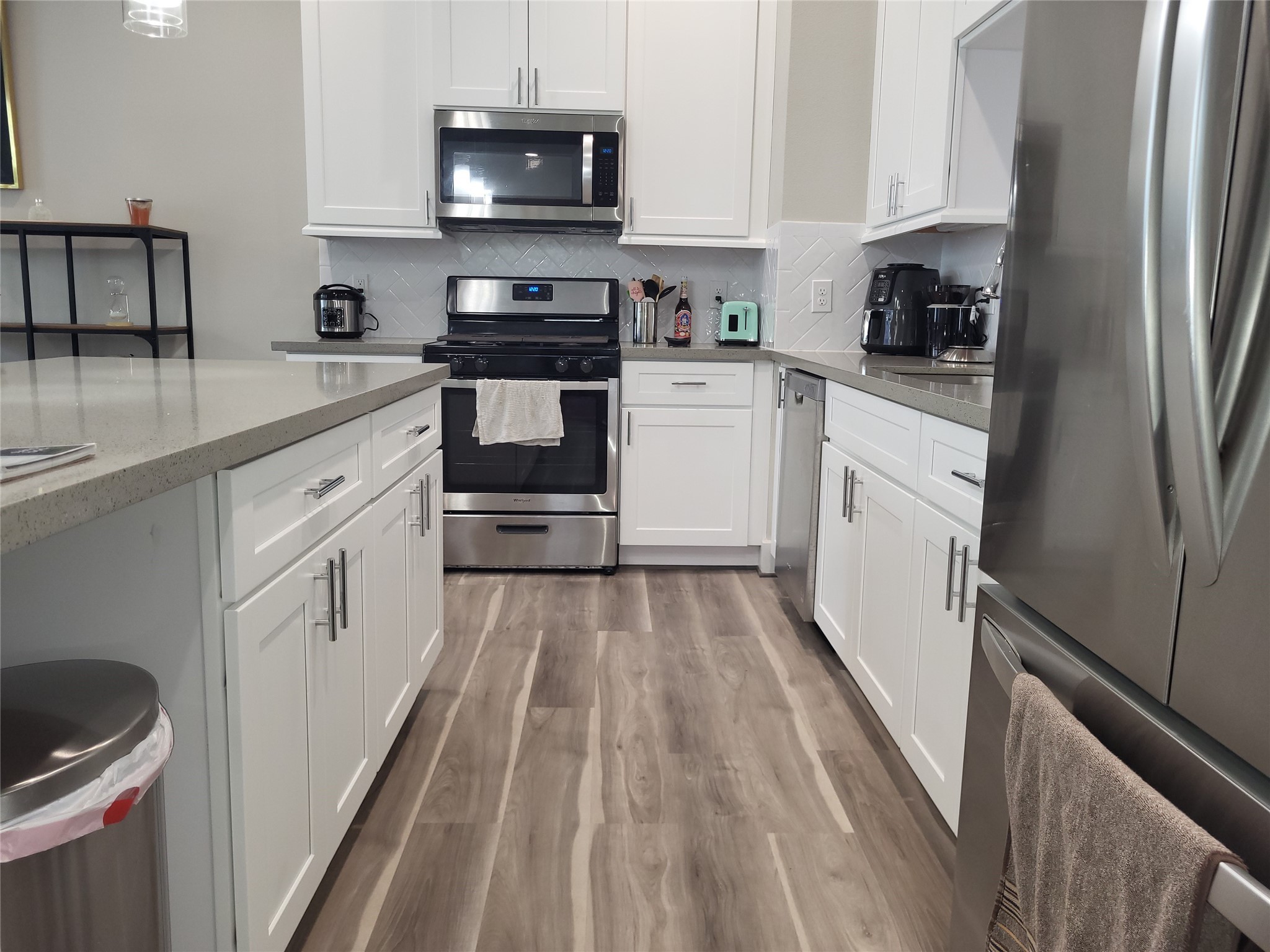 240 Julia Street, Unit A Houston, TX 77022 - Photo 15 of 36 The opposite side of the island is galley style. The owner has replaced the trash area with a trash drawer.