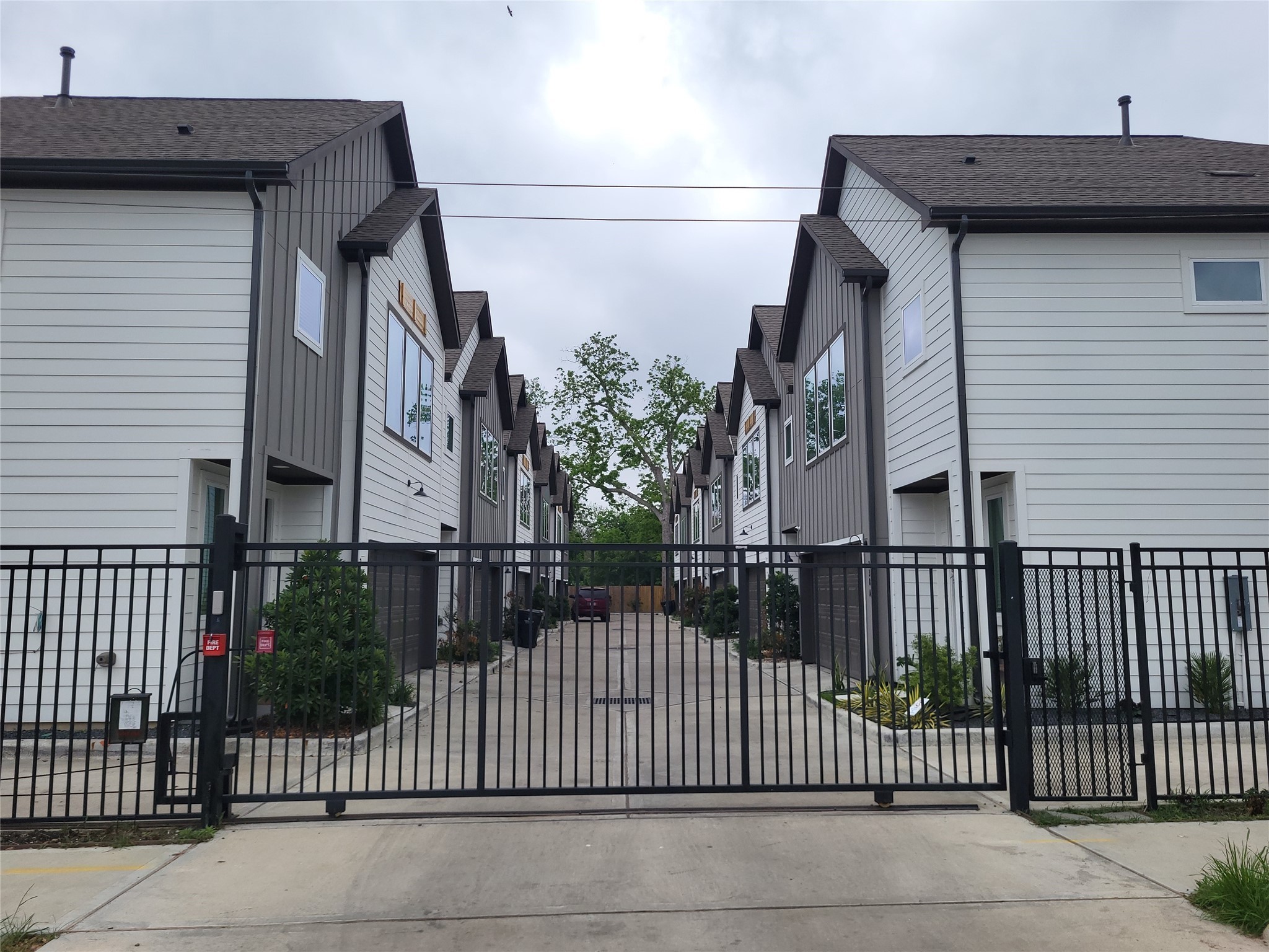240 Julia Street, Unit A Houston, TX 77022 - Photo 3 of 36 A view from outside the automated gate with entry to the complex.