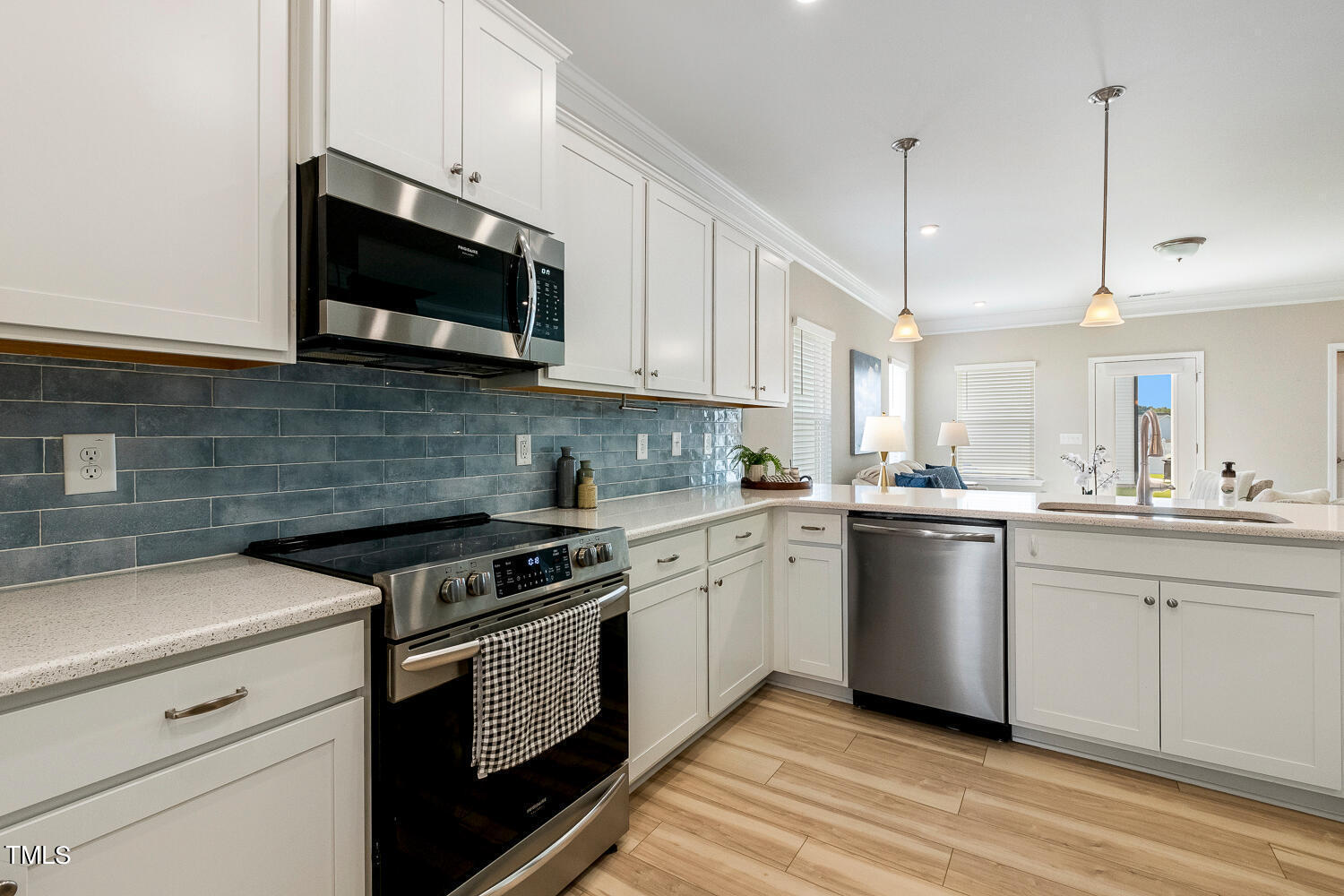 5116 Farm Barn Lane Raleigh, NC 27603 - Photo 12 of 45 a kitchen with stainless steel appliances granite countertop a sink a stove a microwave and wooden cabinets