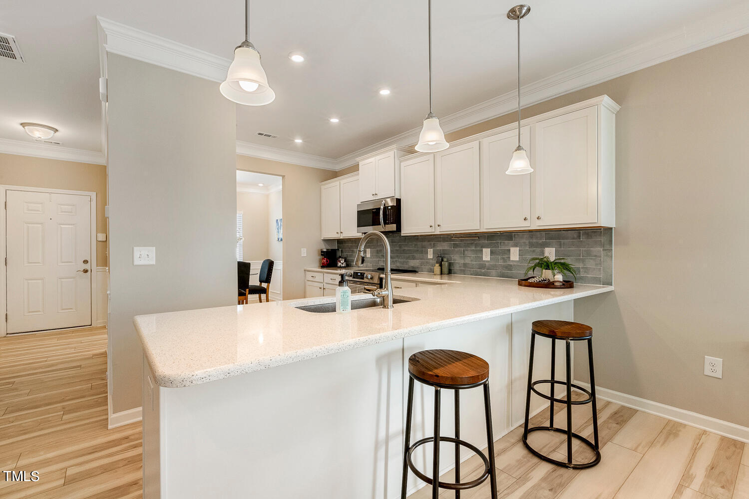 5116 Farm Barn Lane Raleigh, NC 27603 - Photo 14 of 45 a kitchen with stainless steel appliances granite countertop a sink a stove a refrigerator and cabinets with wooden floor