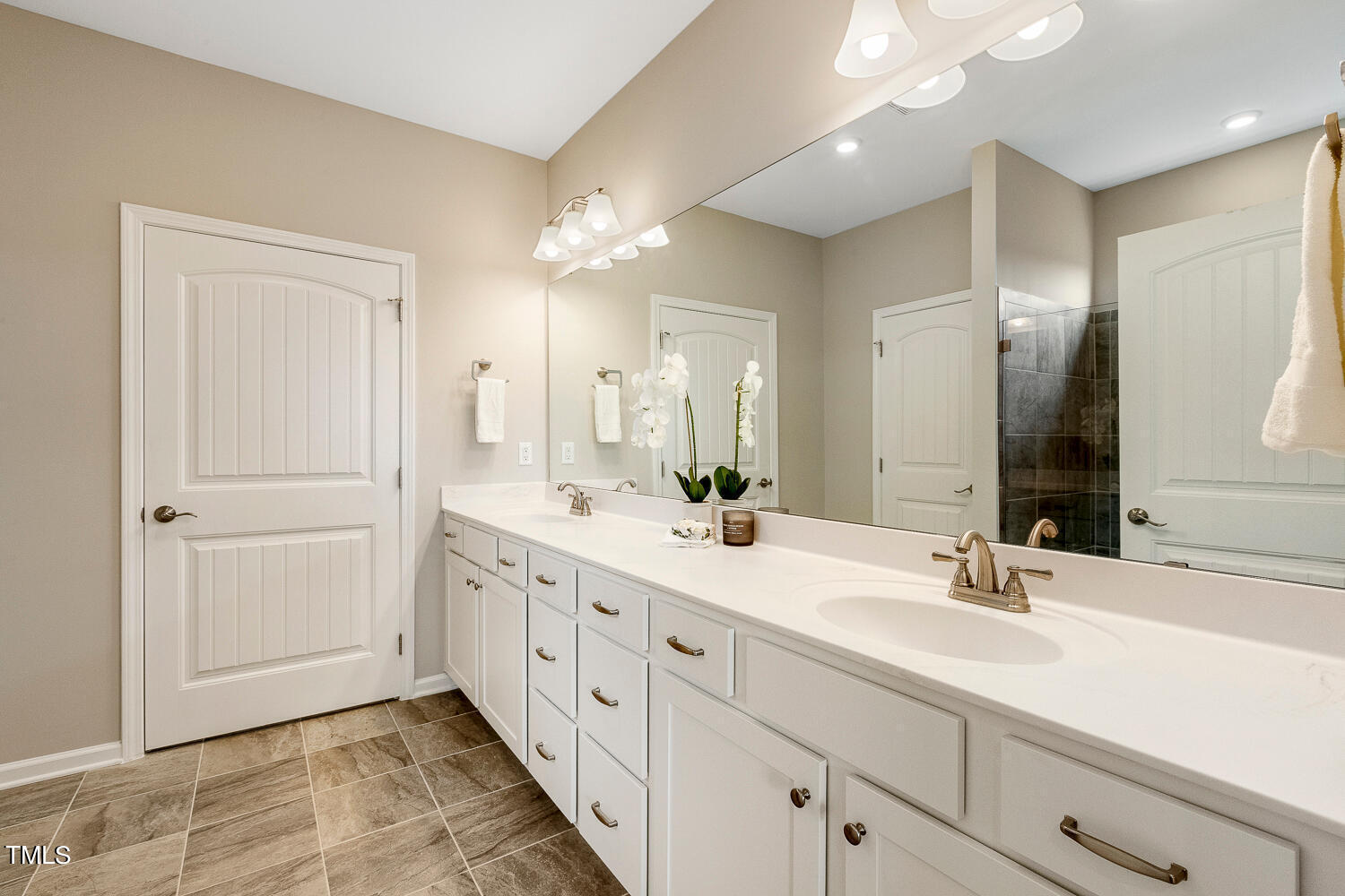 5116 Farm Barn Lane Raleigh, NC 27603 - Photo 24 of 45 a bathroom with double sink and a mirror