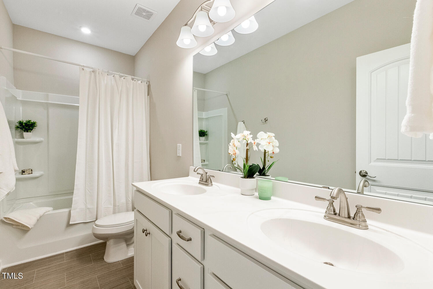 5116 Farm Barn Lane Raleigh, NC 27603 - Photo 32 of 45 a bathroom with a double vanity sink mirror and toilet