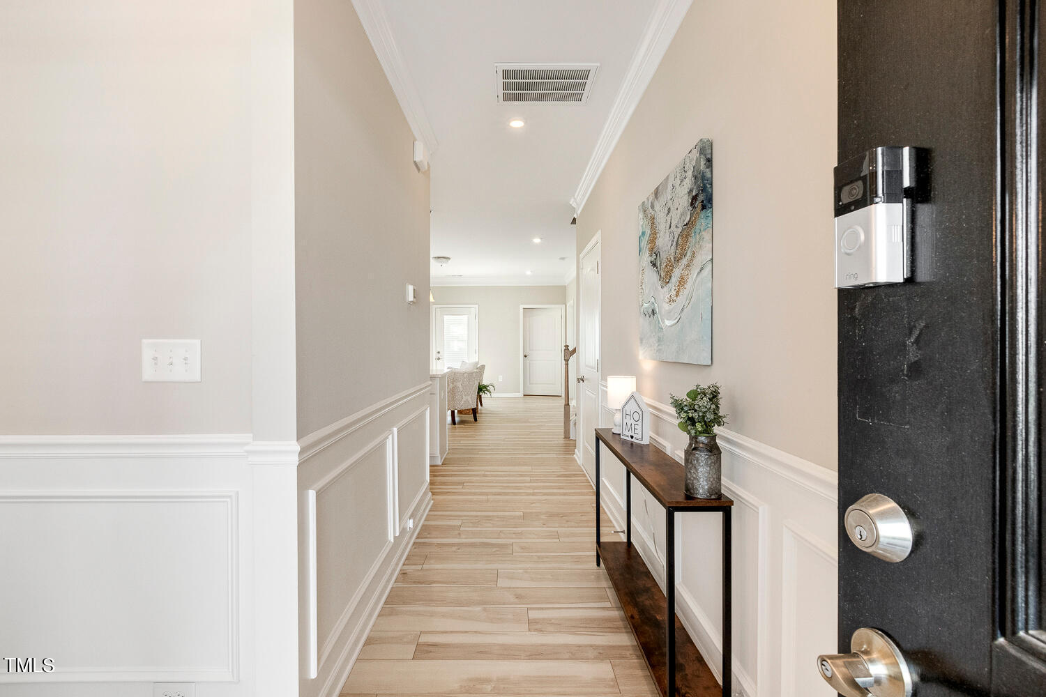 5116 Farm Barn Lane Raleigh, NC 27603 - Photo 4 of 45 a view of a hallway with wooden floor and staircase