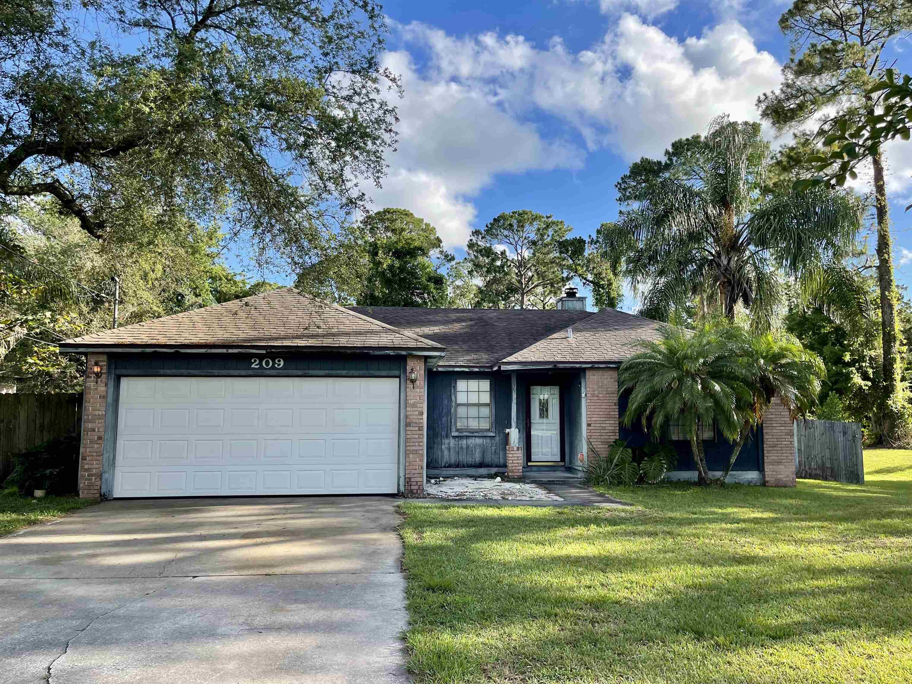 209 Gerona Road St. Augustine, FL 32086 - Photo 1 of 23 a front view of a house with a garden