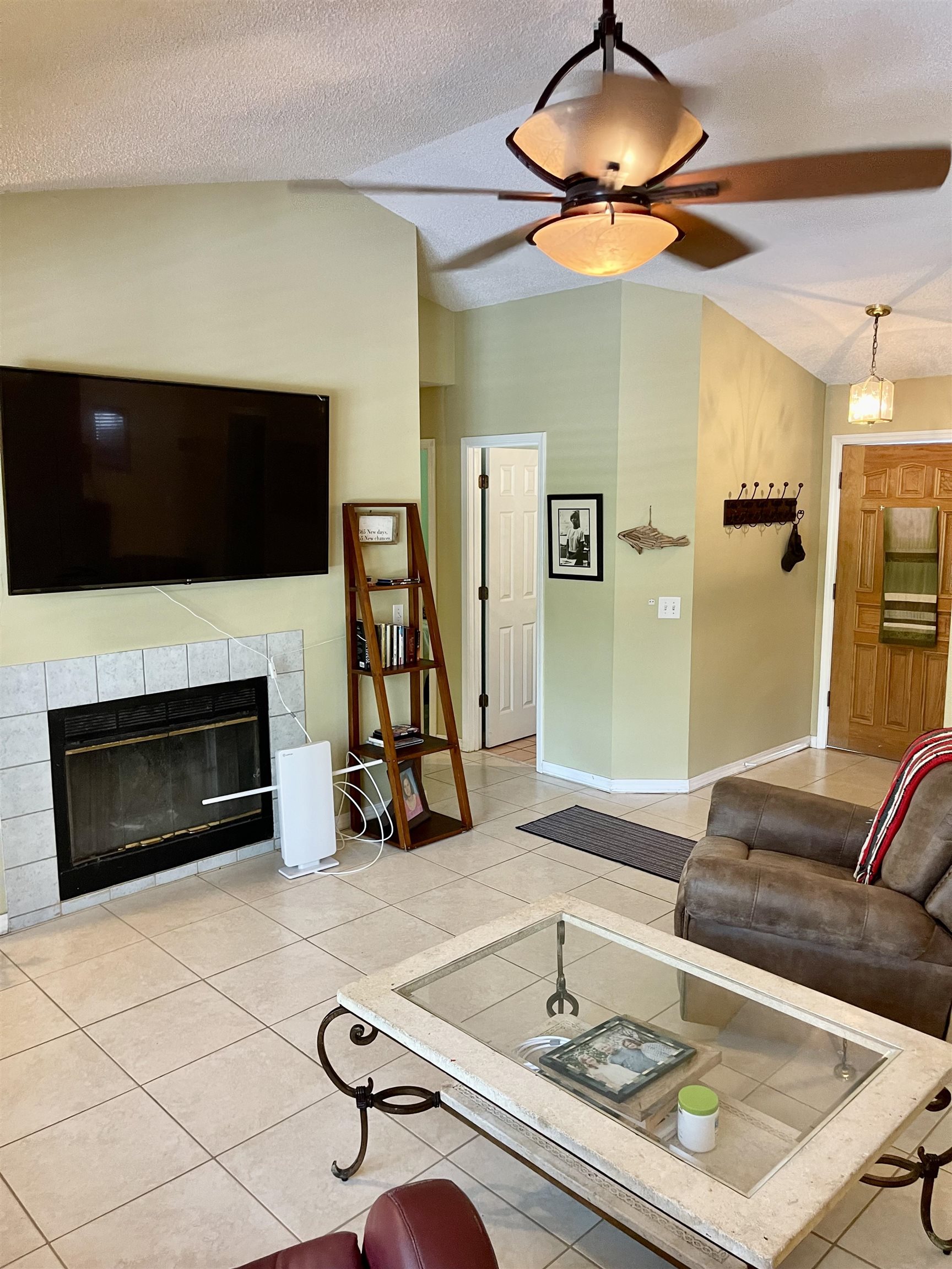 209 Gerona Road St. Augustine, FL 32086 - Photo 8 of 23 a living room with furniture a flat screen tv and a fireplace