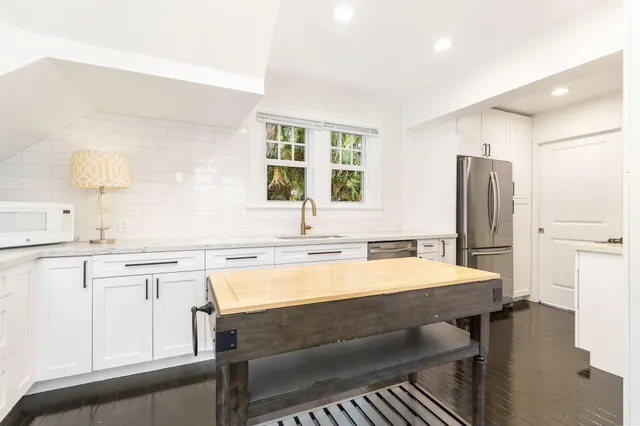 a kitchen with a stove a sink and a refrigerator