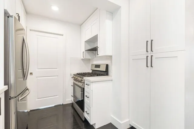 a kitchen with a stove and a refrigerator