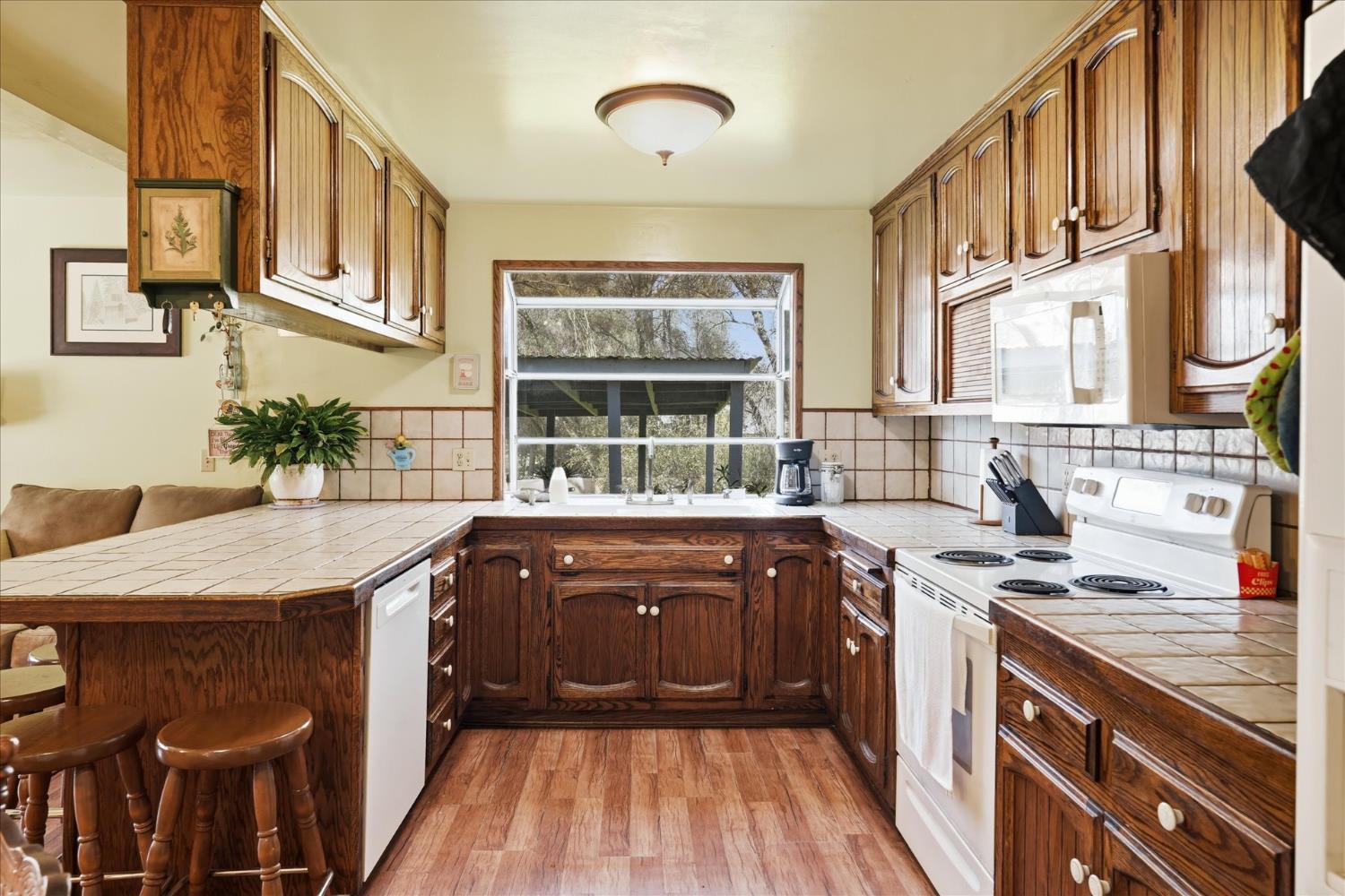 a kitchen with stainless steel appliances granite countertop a sink and wooden cabinets