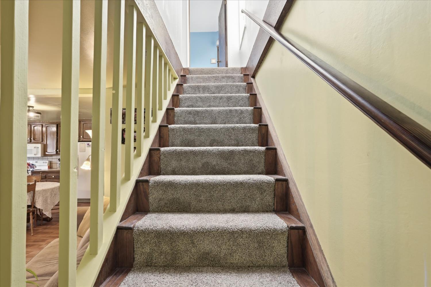 31325 Delaware Road Coarsegold, CA 93614 - Photo 30 of 39 a view of staircase with lots of frames on wall and a large window