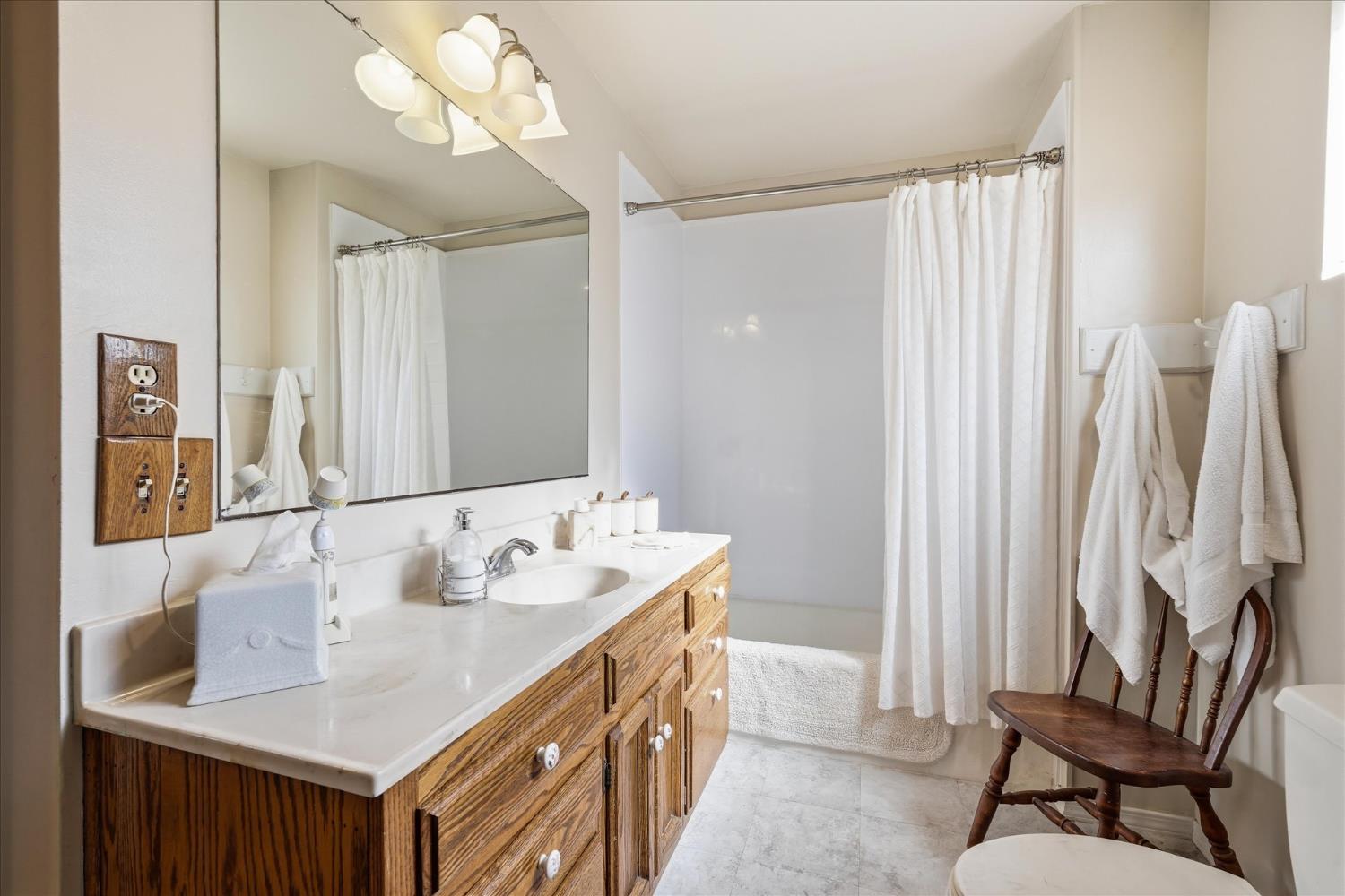 31325 Delaware Road Coarsegold, CA 93614 - Photo 5 of 39 a bathroom with a double vanity sink and a mirror
