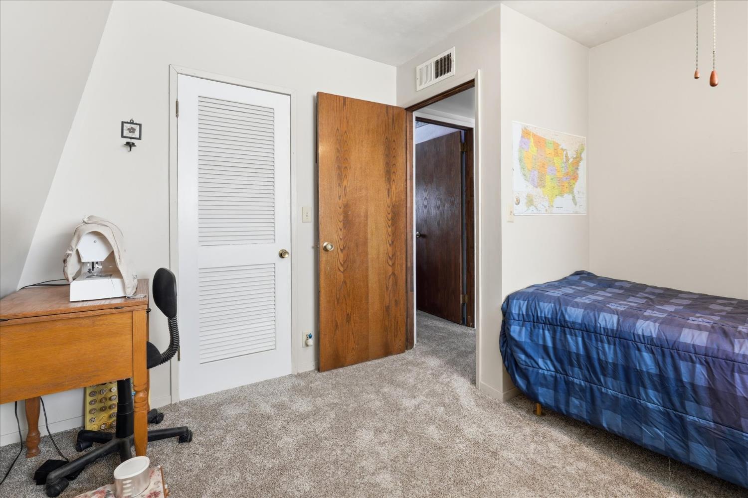 31325 Delaware Road Coarsegold, CA 93614 - Photo 6 of 39 a bedroom with a bed and a dresser in it