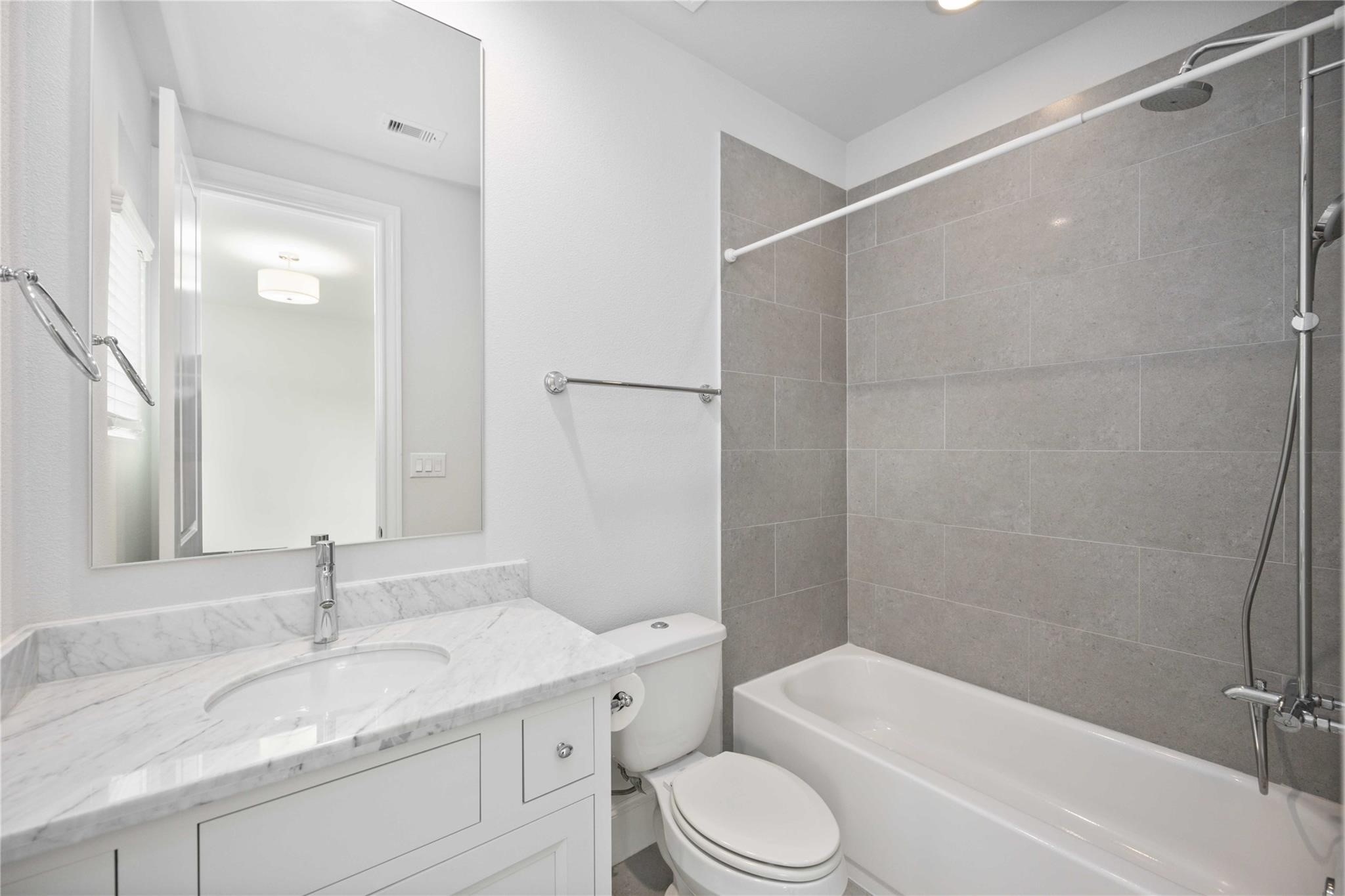 10919 Grove Tree Lane Houston, TX 77043 - Photo 11 of 43 a bathroom with a granite countertop sink toilet and shower