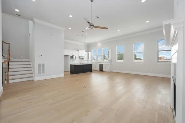 a view of kitchen and hall with wooden floor
