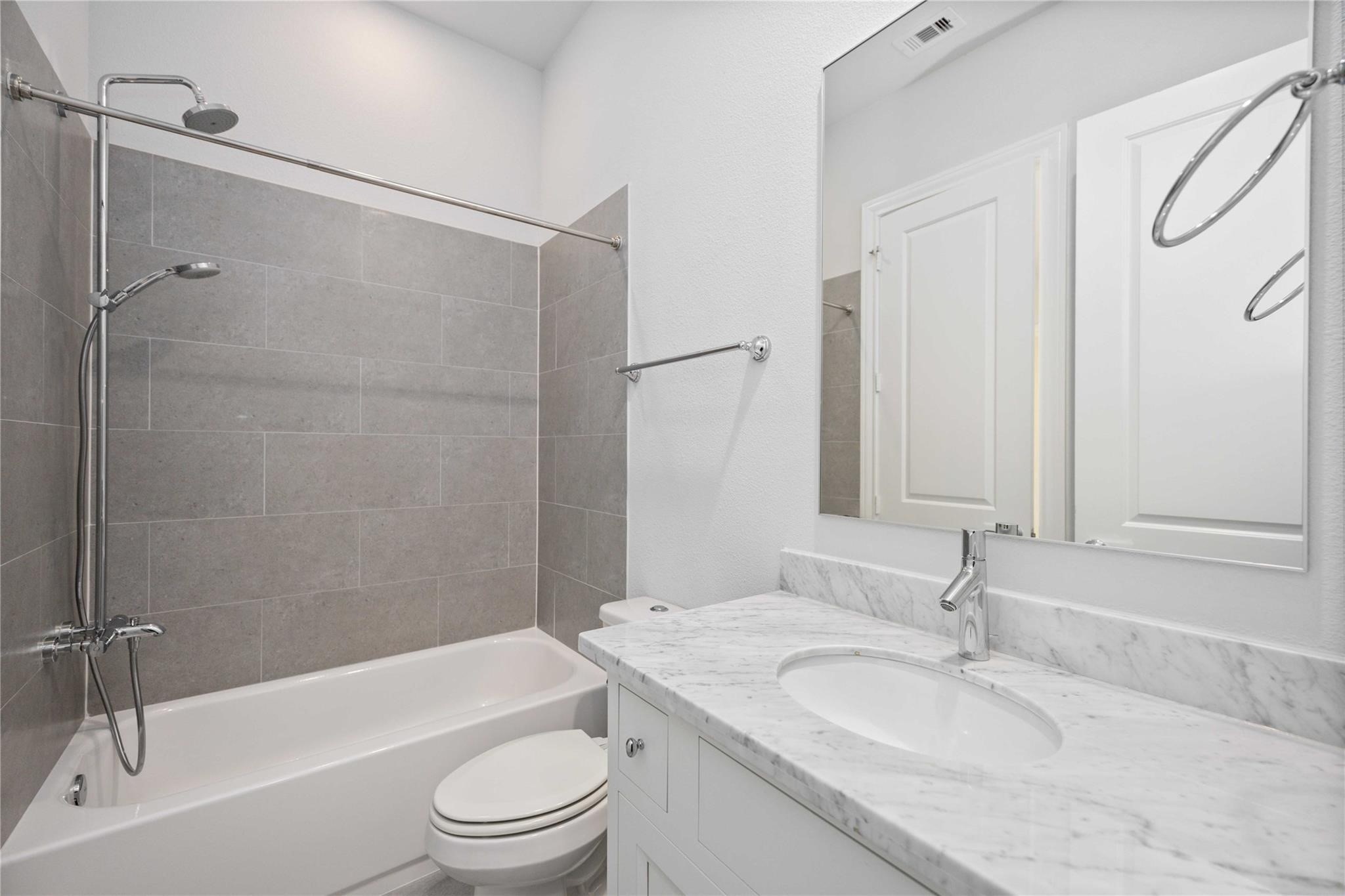 10919 Grove Tree Lane Houston, TX 77043 - Photo 22 of 43 a bathroom with a granite countertop sink toilet and shower
