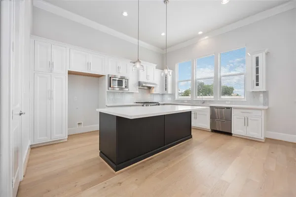 a kitchen with a white cabinets counter space a sink and a window