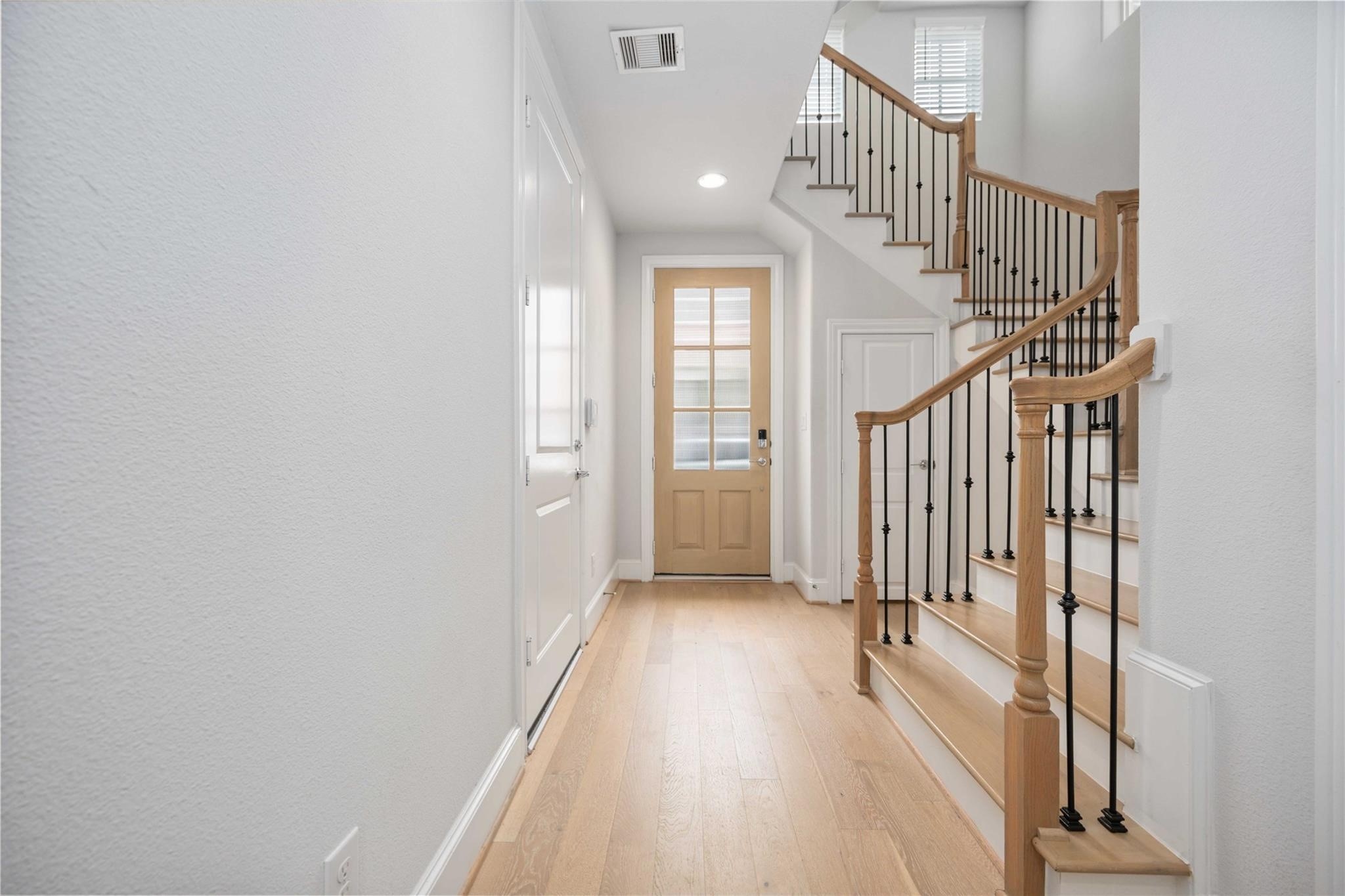 10919 Grove Tree Lane Houston, TX 77043 - Photo 4 of 43 a view of entryway with wooden floor