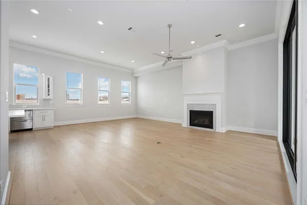 an empty room with wooden floor and fireplace