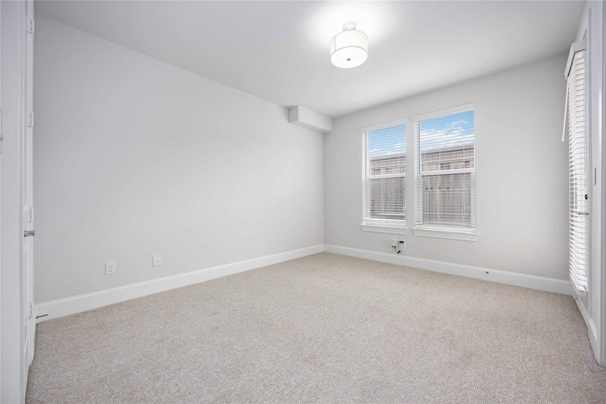 10919 Grove Tree Lane Houston, TX 77043 - Photo 7 of 43 an empty room with a empty space and windows